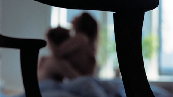 man-observing-stoma-pouch-on-his-abdomen-thinking-about-body-image-concerns-with-a-stoma